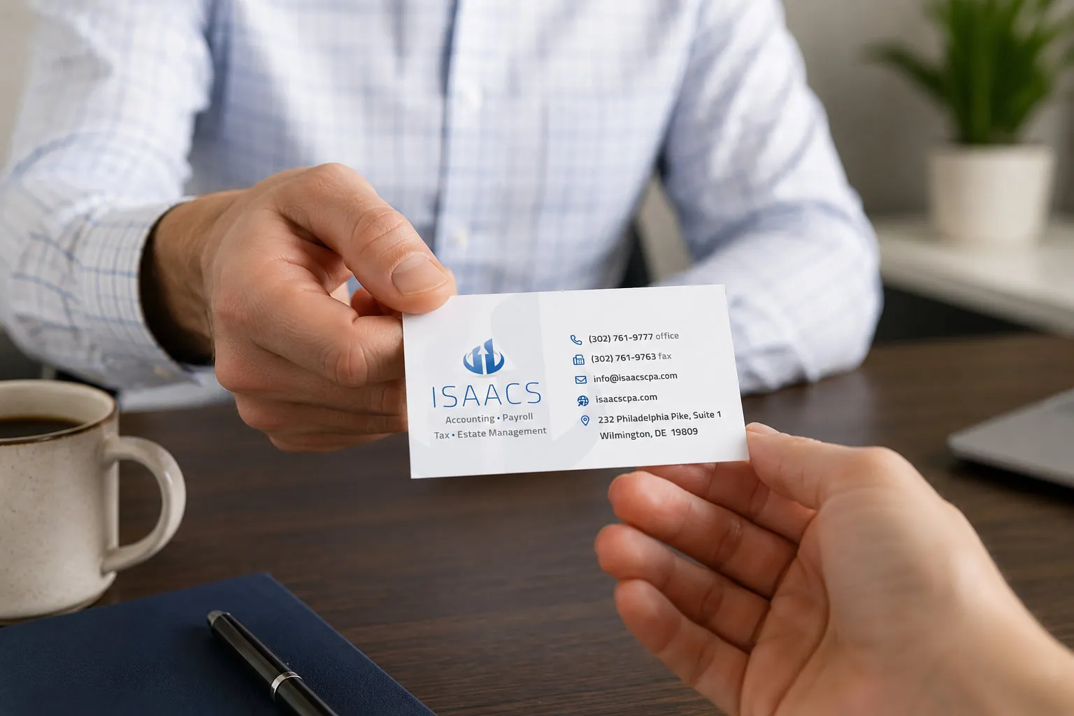 Isaacs & Associates business card design being handed to a client